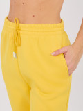 Žluté teplákové kalhoty s vysokým pasem a kapsami